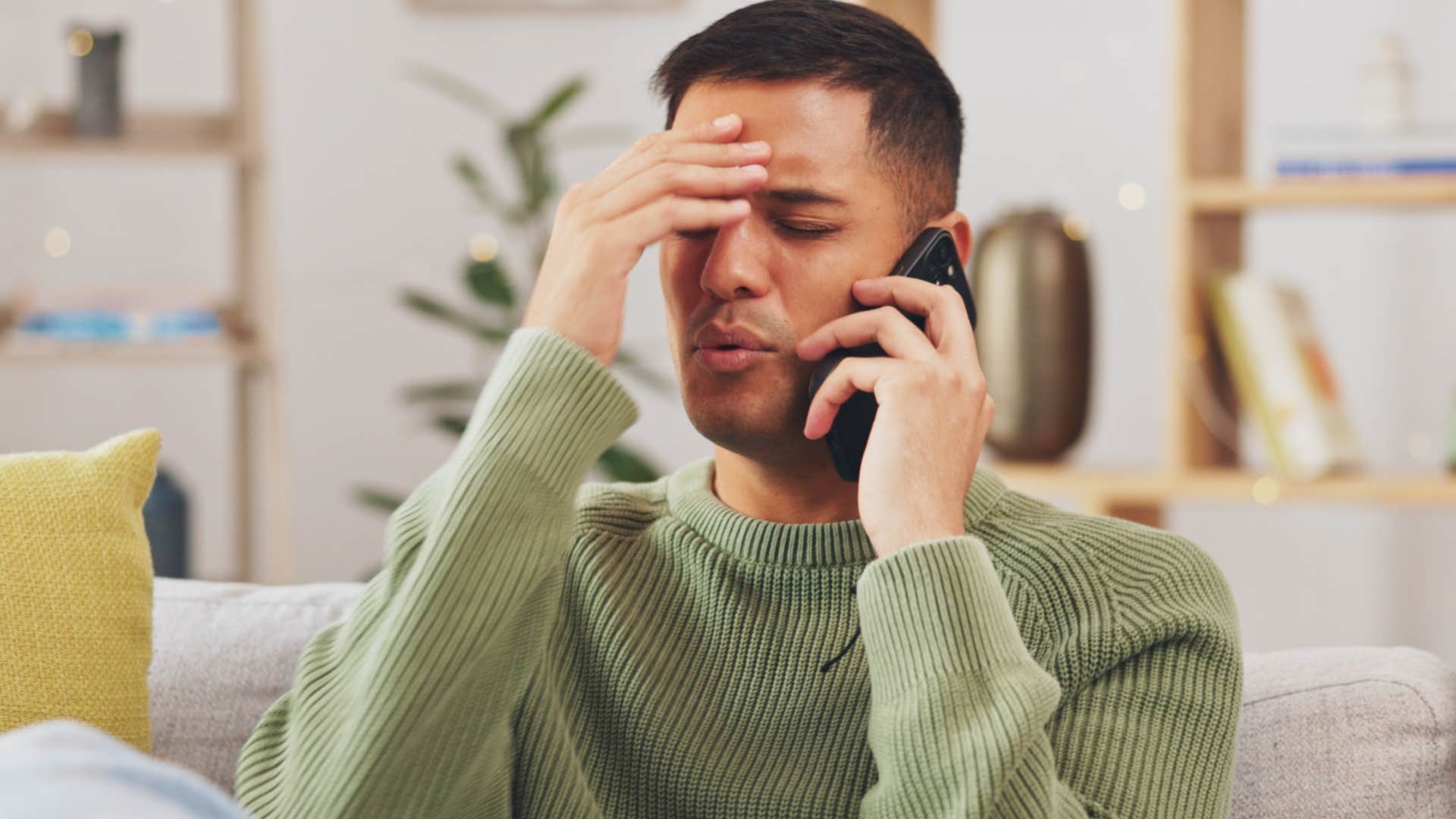 Man looking frustrated on the phone