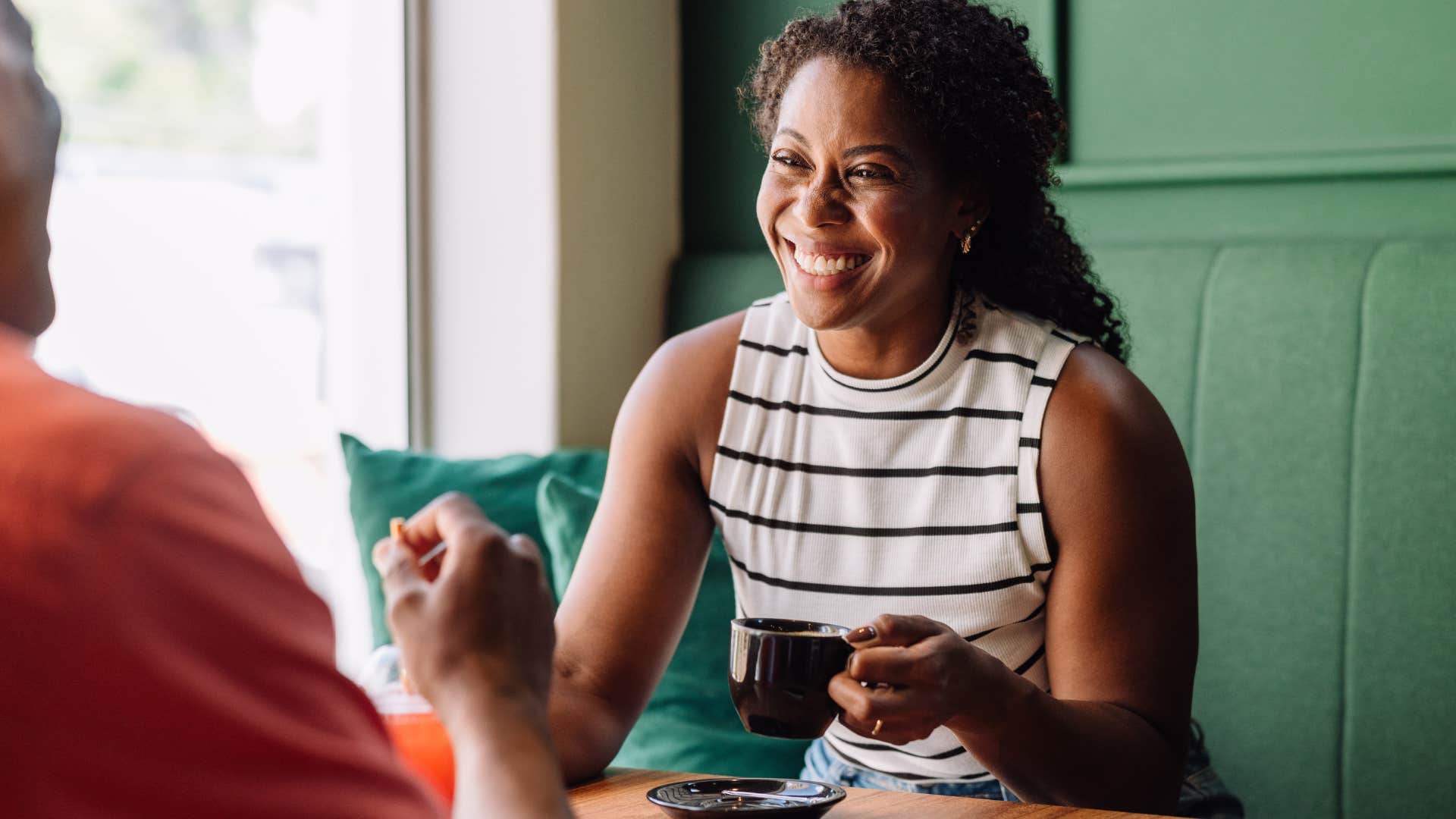 Woman smiling while talking to a man