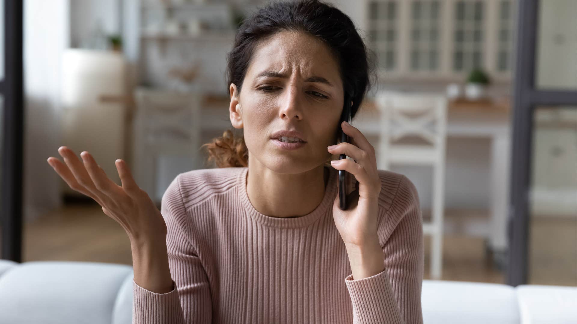 Woman looking upset talking on the phone