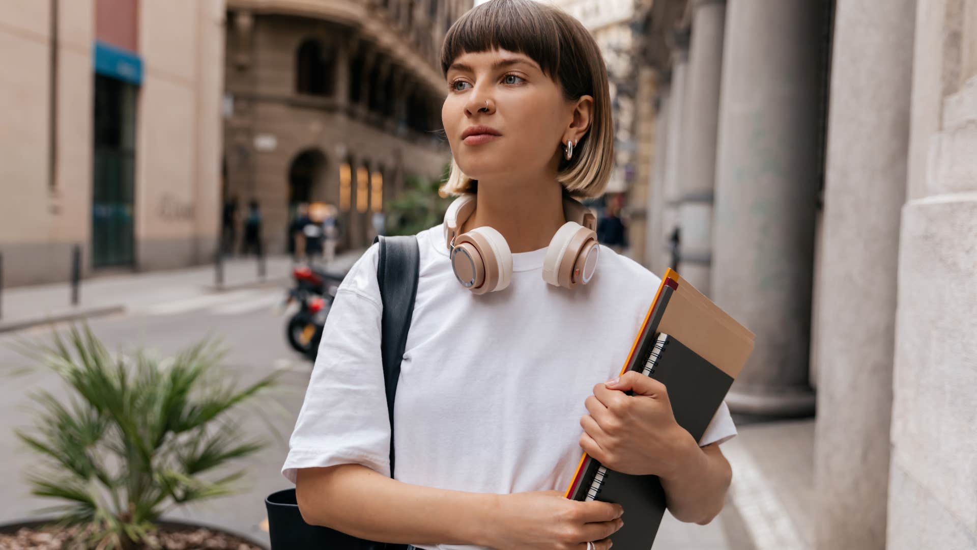 Woman walking around outside with her headphones on