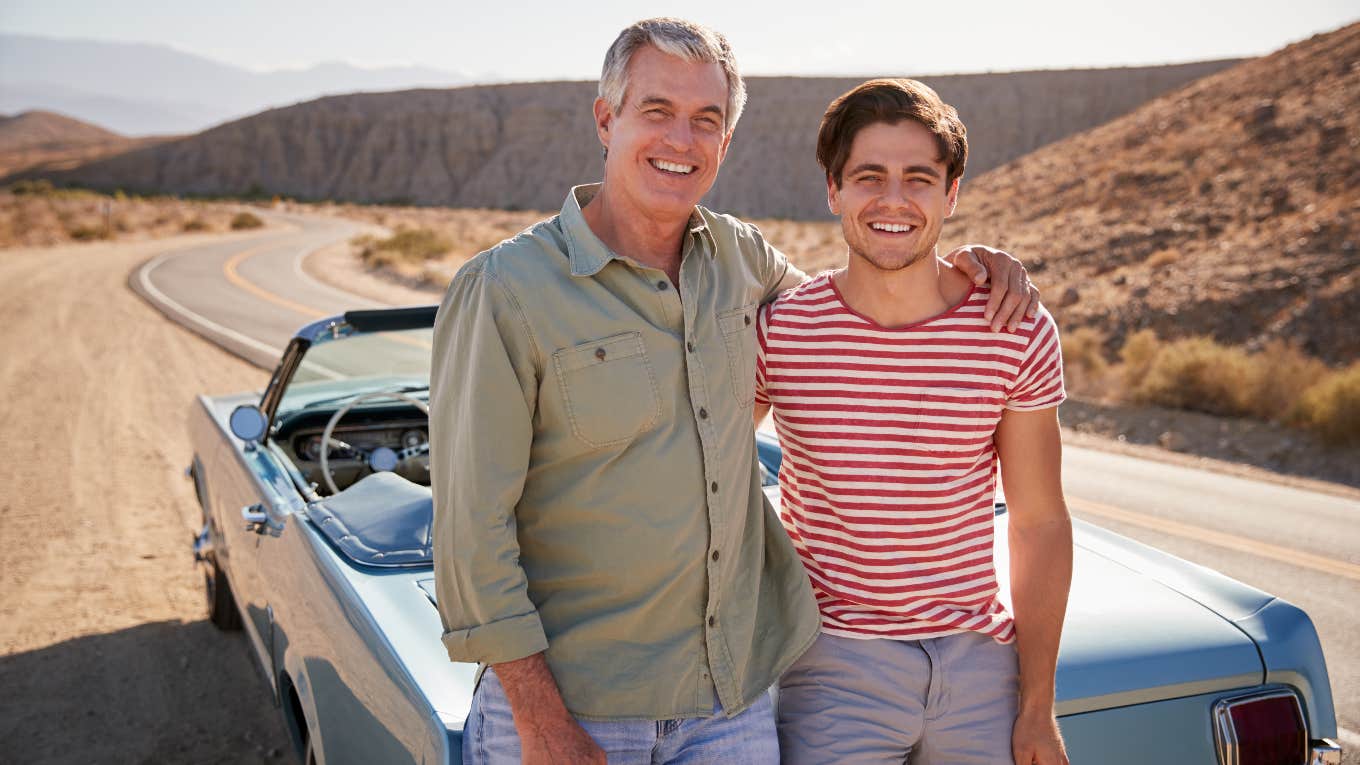 Dad and son in front of dream car