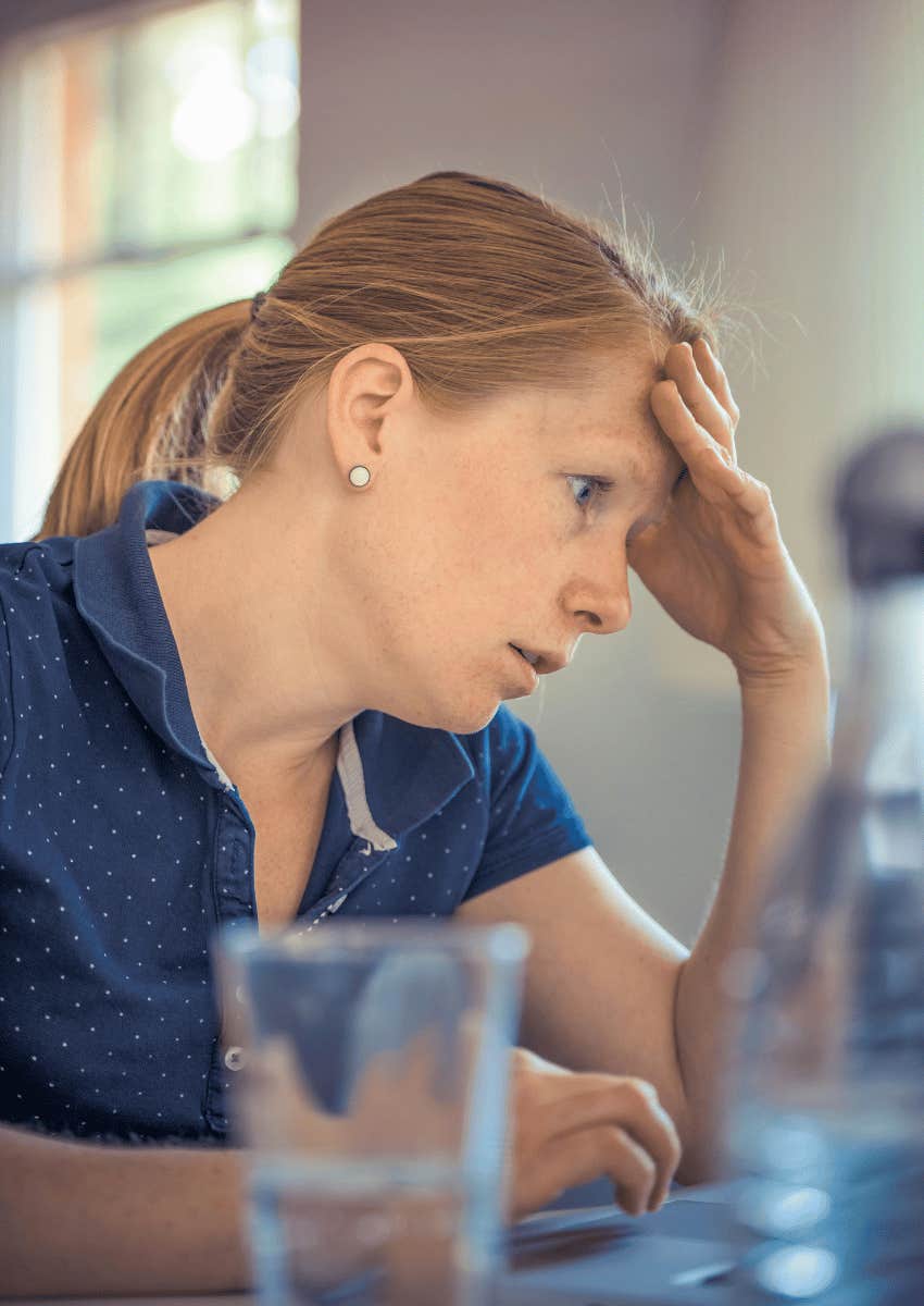 stressed woman working on a laptop