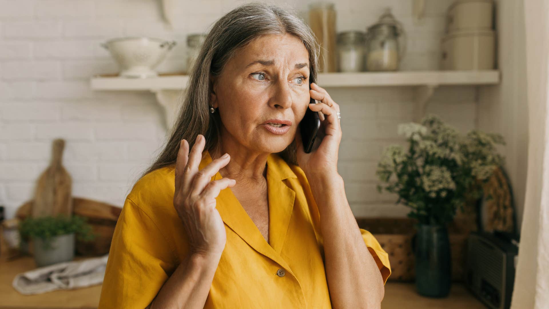 Older woman looking upset talking on the phone