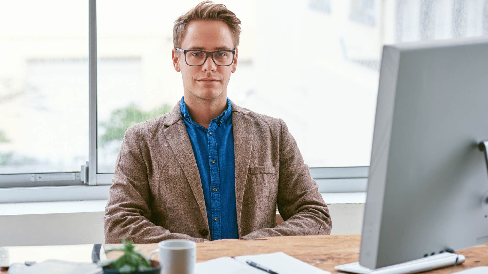 man sitting down on office chair 