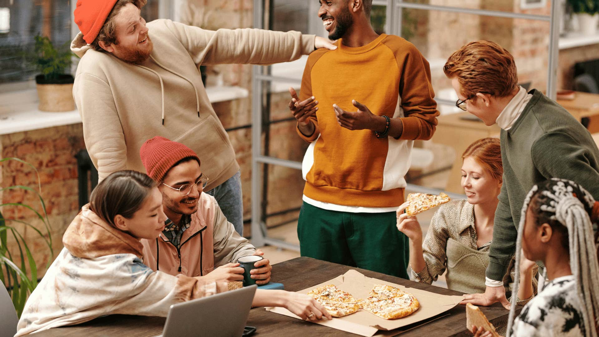 friends talking while eating pizza