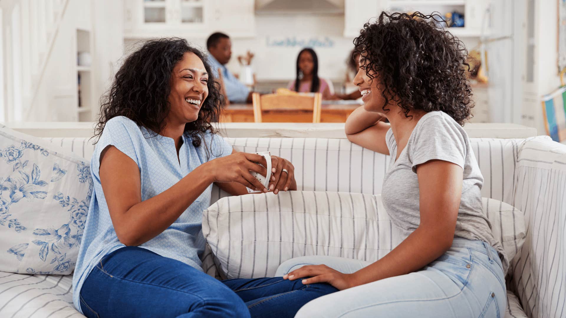 mother and daughter talking on the couch