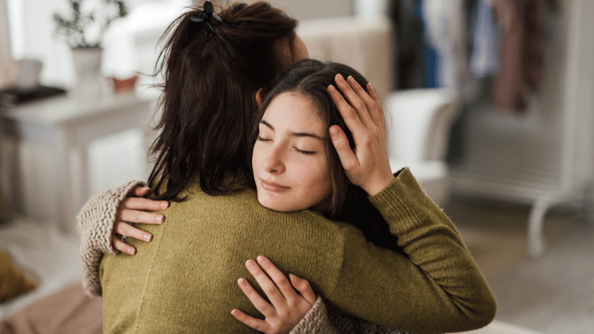 mom hugging daughter comfortingly 