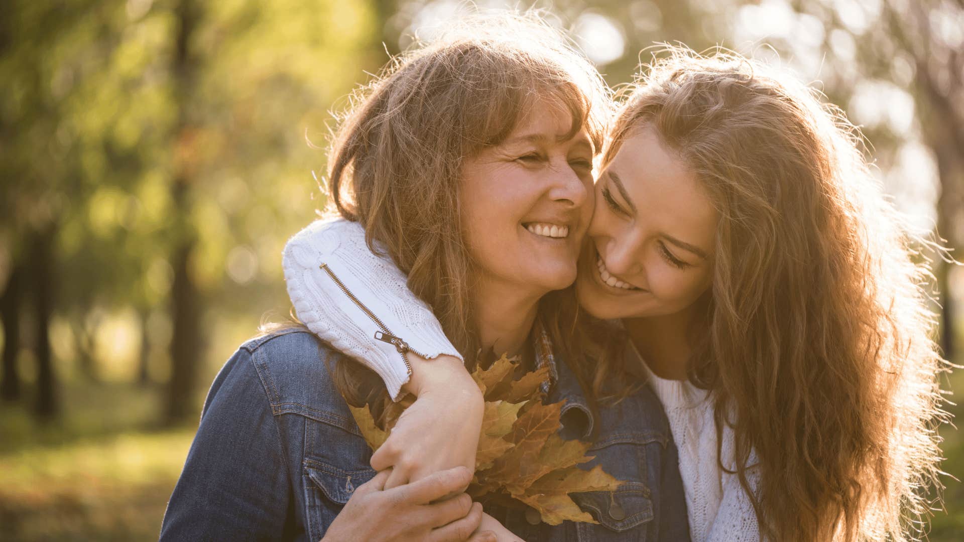 mother and daughter hugging outside 