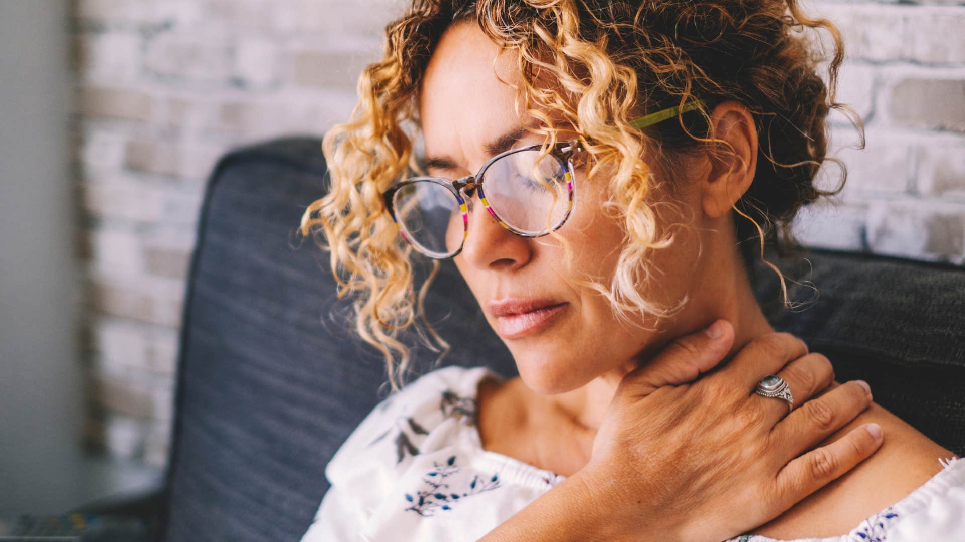 Woman looking upset on her couch