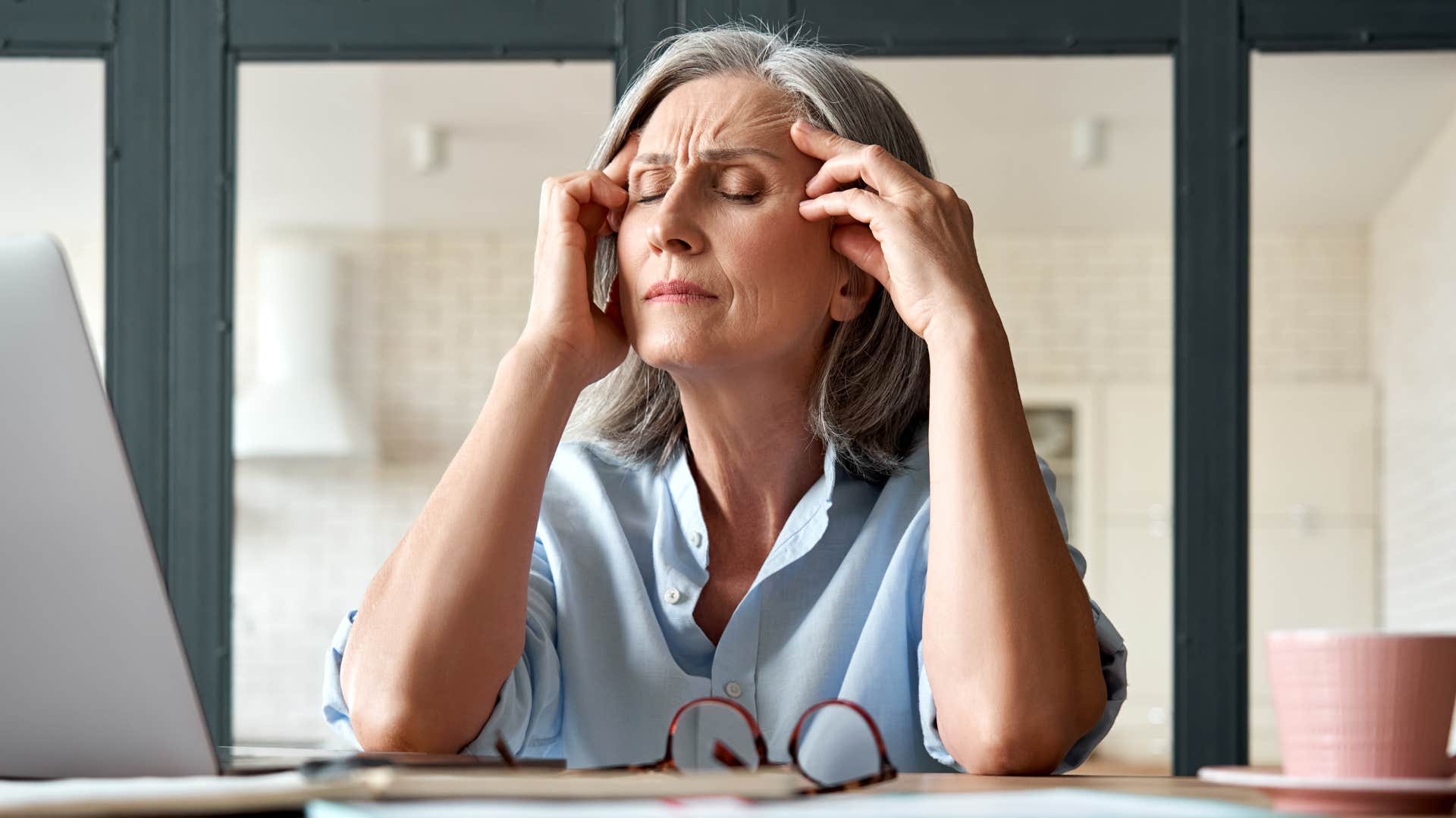 Older woman looking annoyed talking on the phone