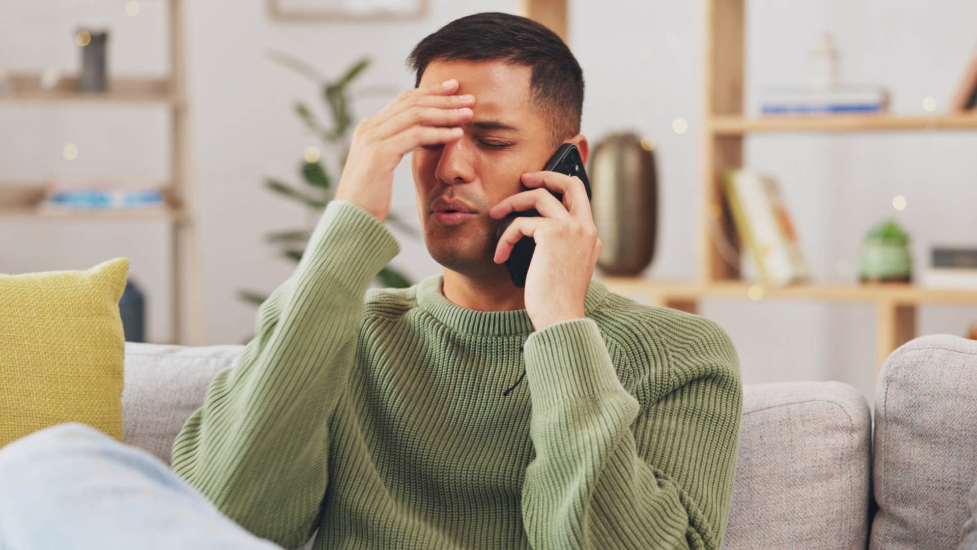 Man looking annoyed while talking on the phone