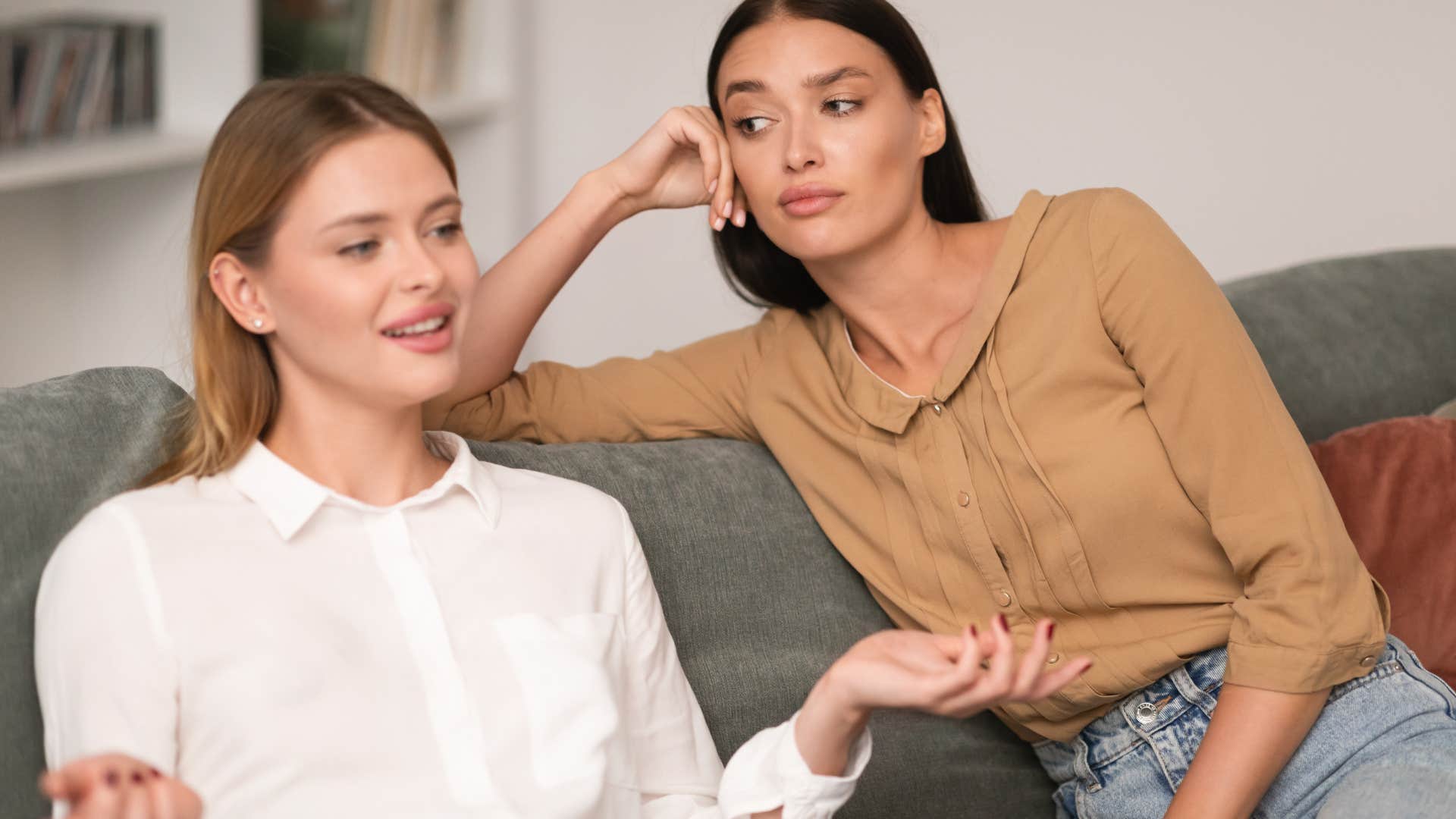 Woman looking judgmental behind her other friend.