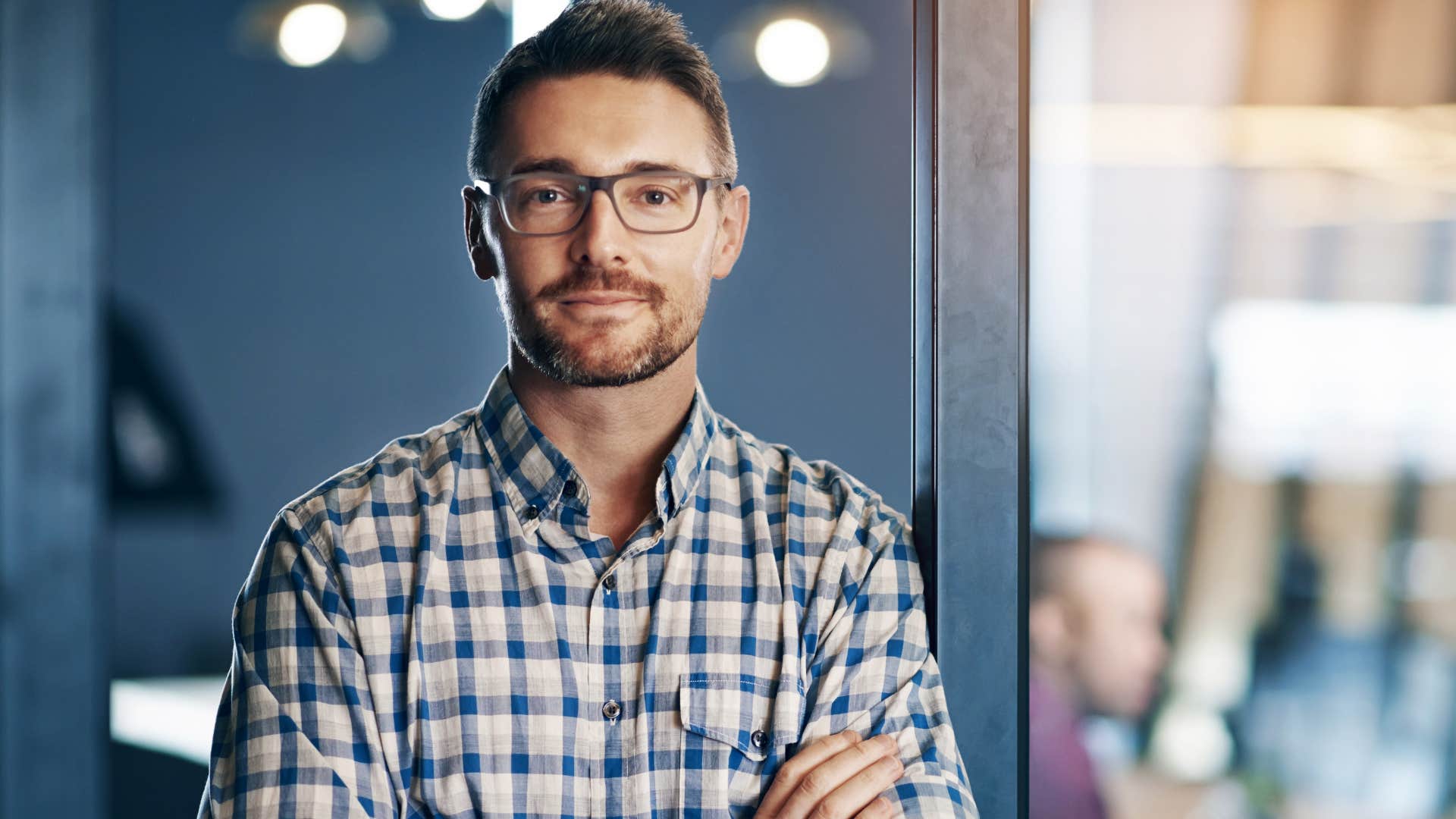 Confident man smiling in an office.