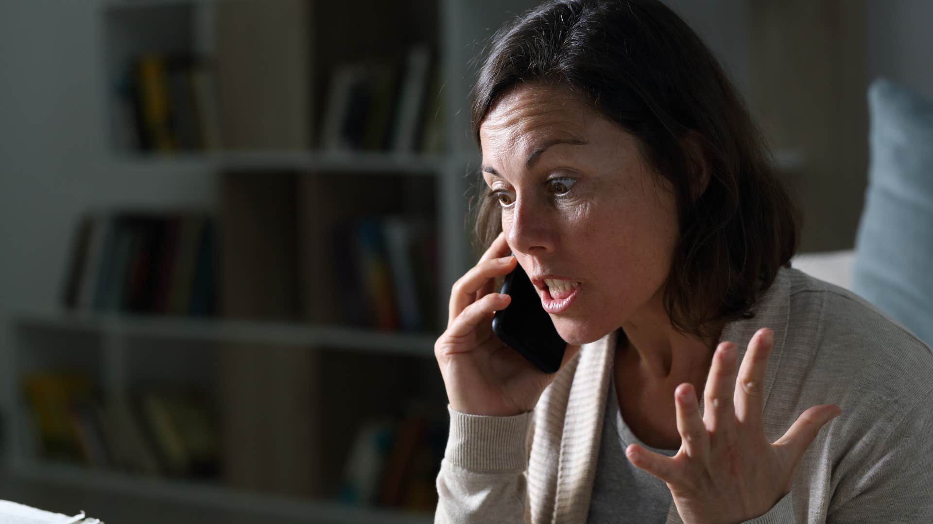 Angry woman yelling into her cell phone.