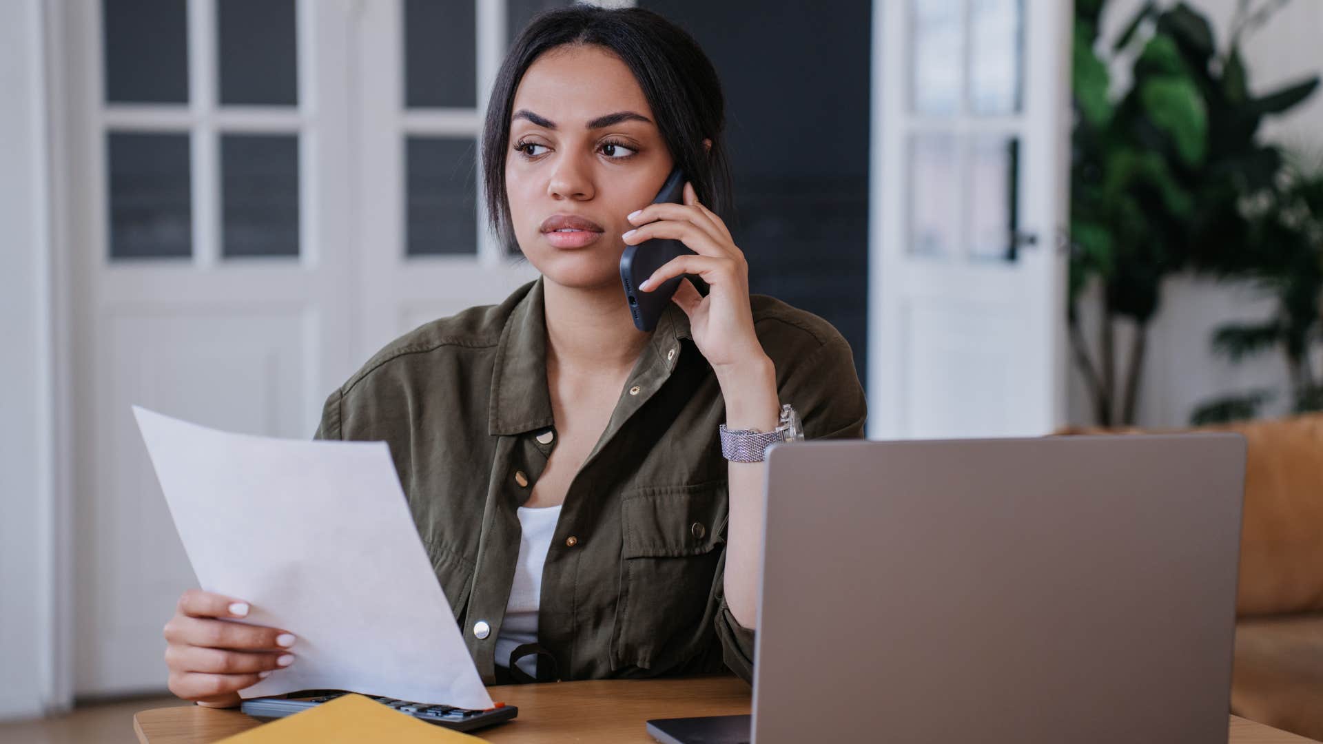 Upset woman talking on the phone.