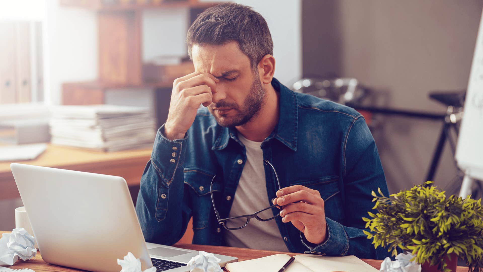 man not feeling good while working 