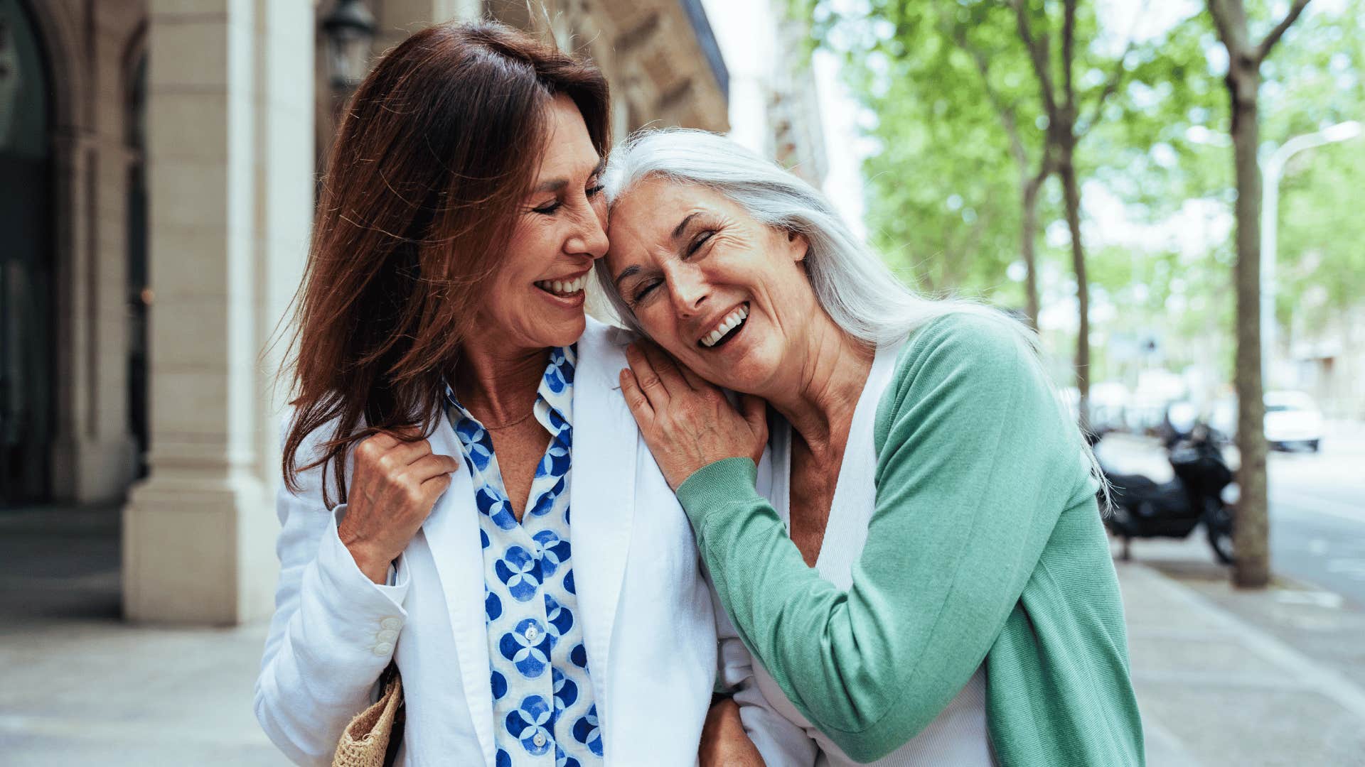 two women walking and laughing