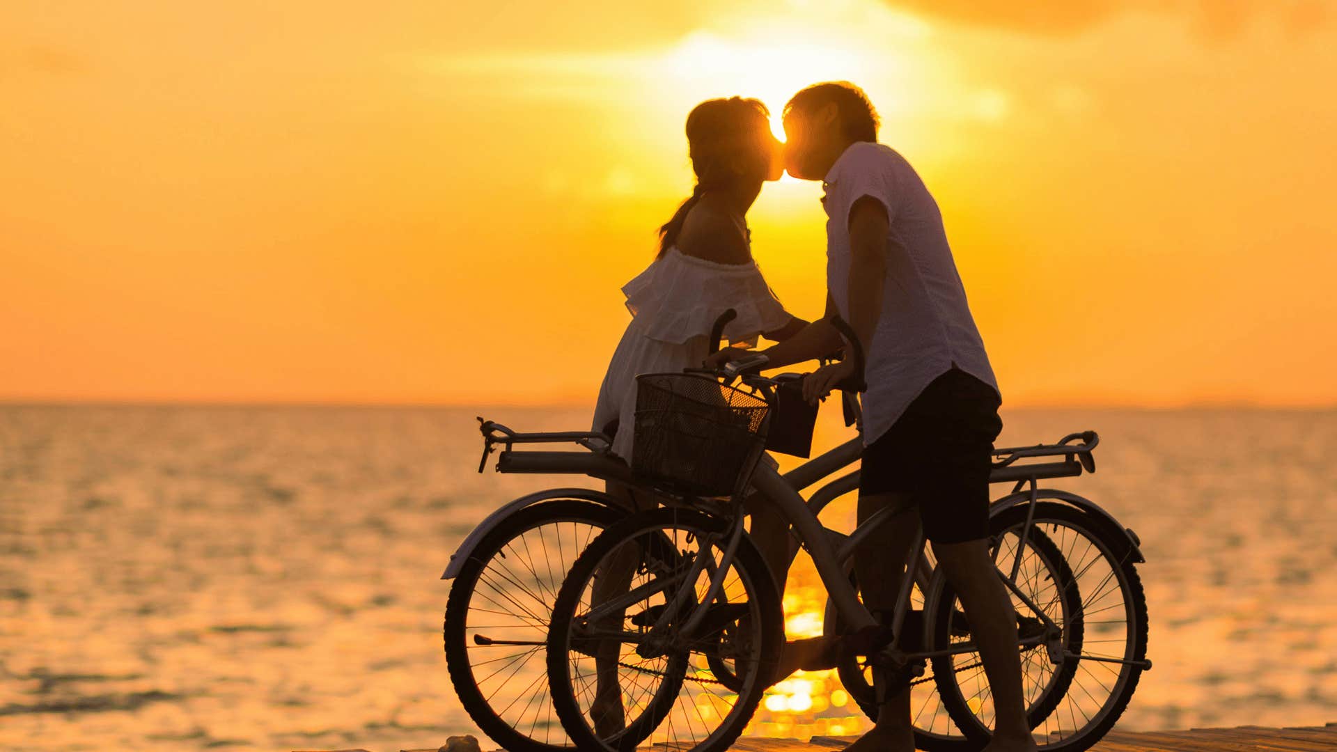 couple on bikes kissing