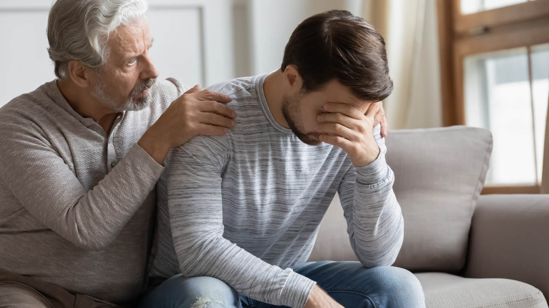 Dad comforting his upset adult son