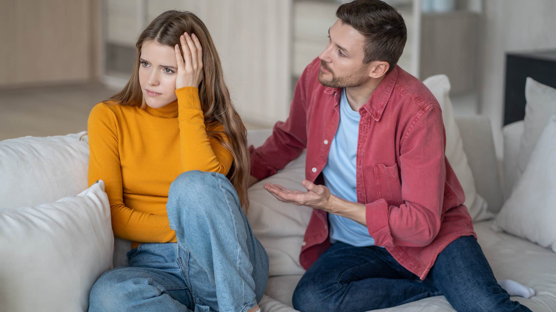 Man arguing with his upset wife on the couch