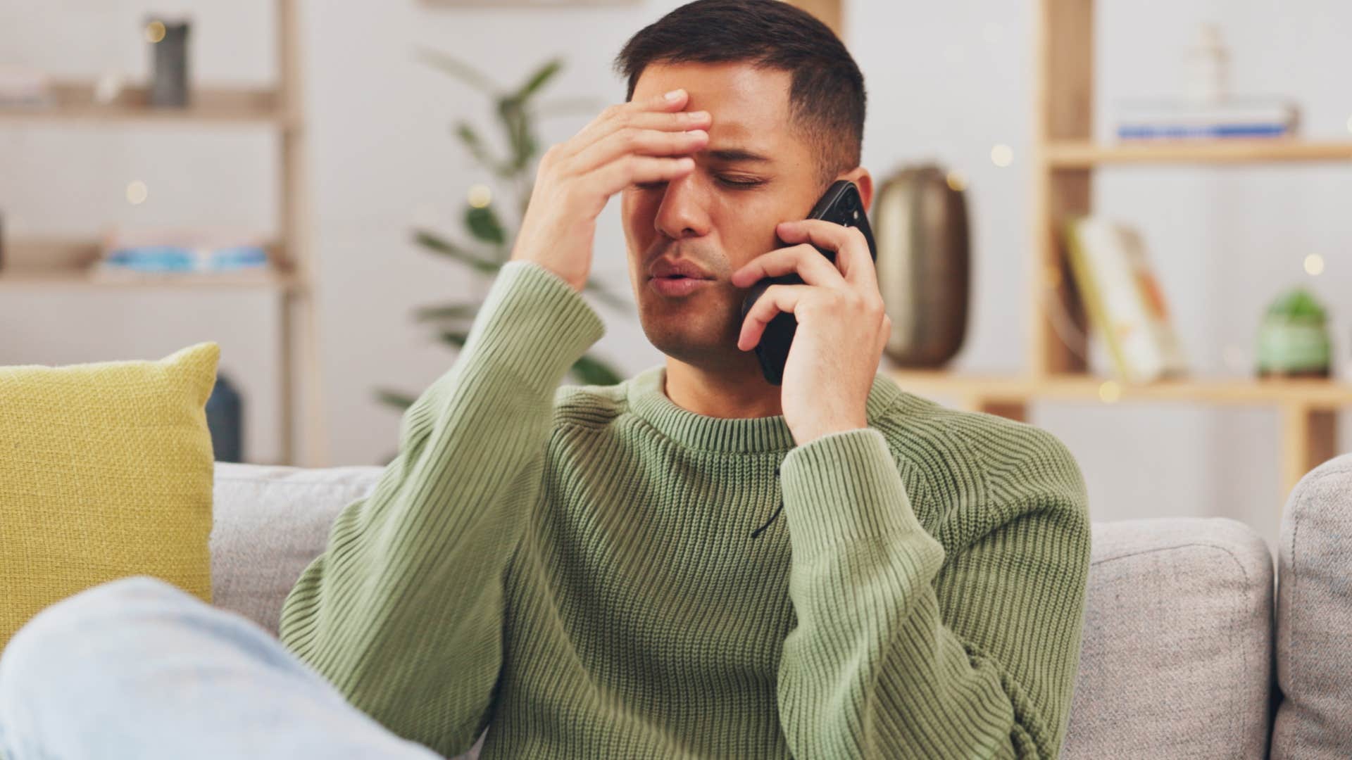 Man looking annoyed while talking on the phone