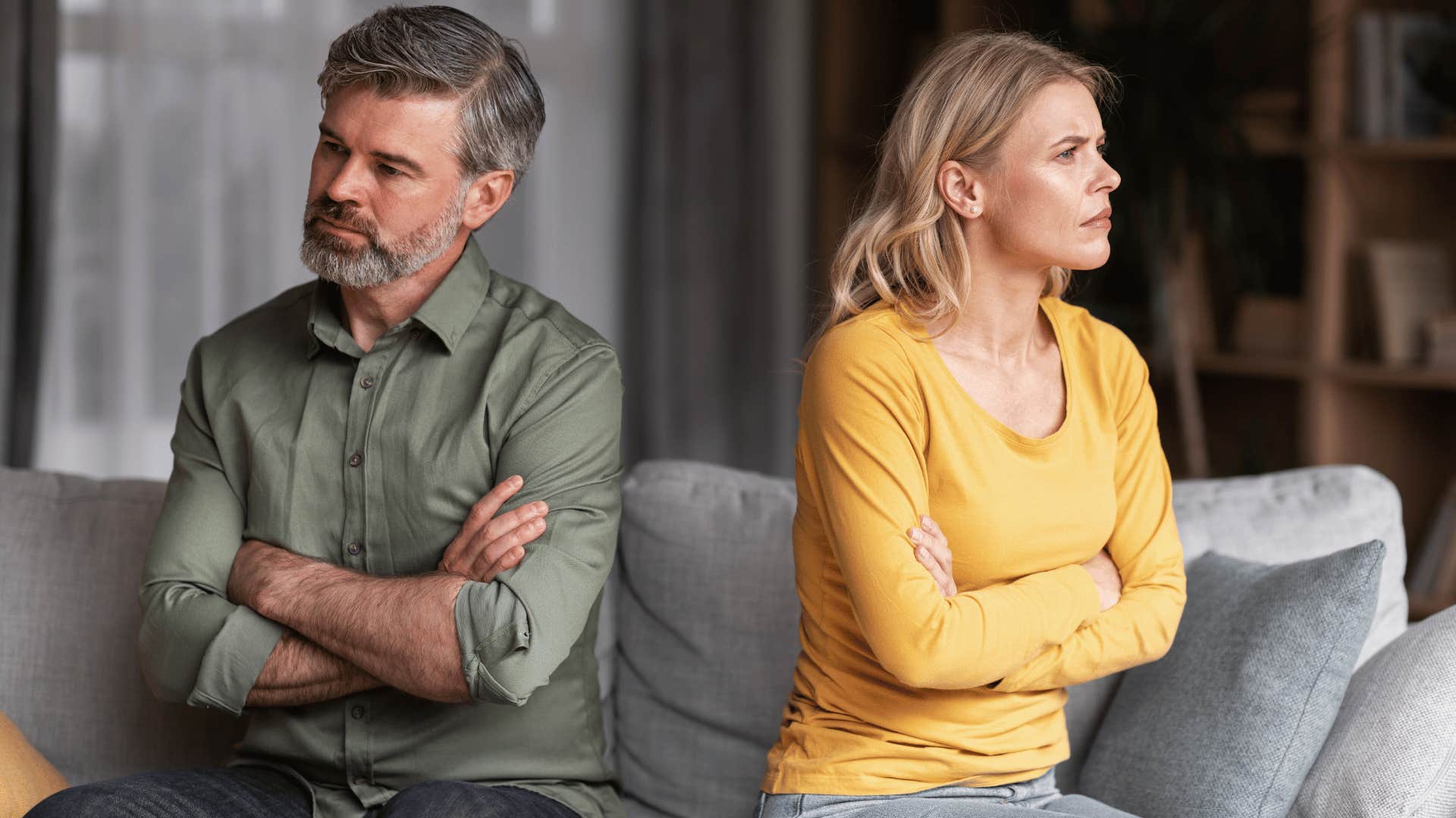 man and woman crossing arms ignoring each other