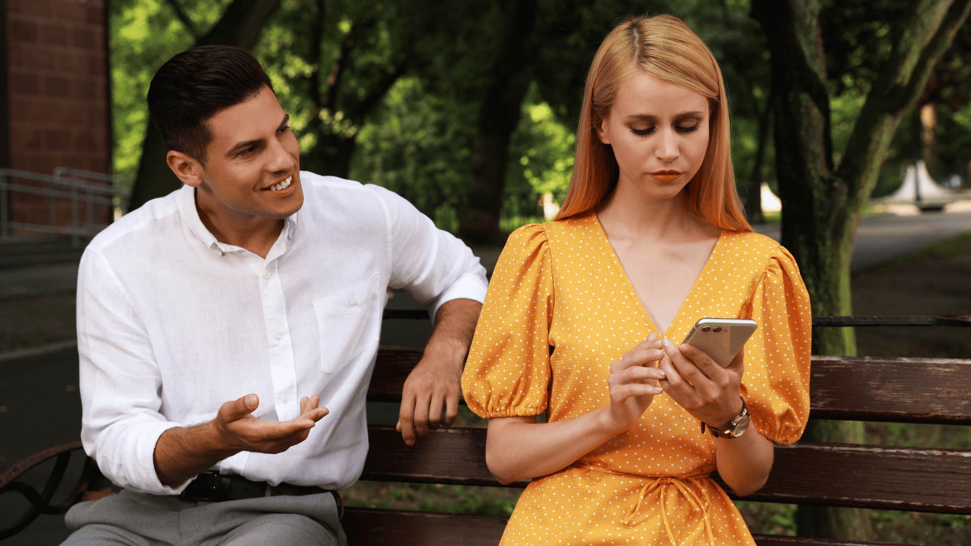 man trying to talk to woman while woman ignores him 