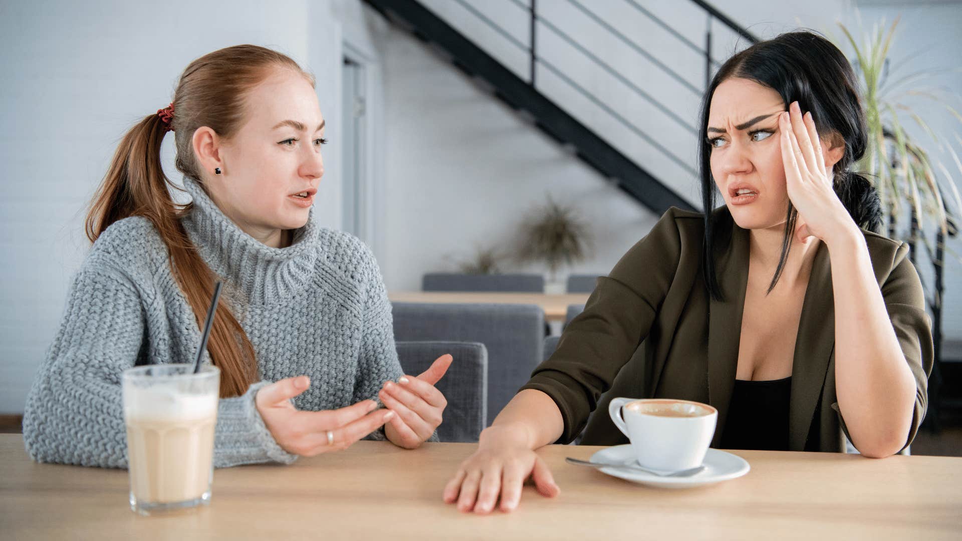 woman explaining while other woman looks at her disgusted