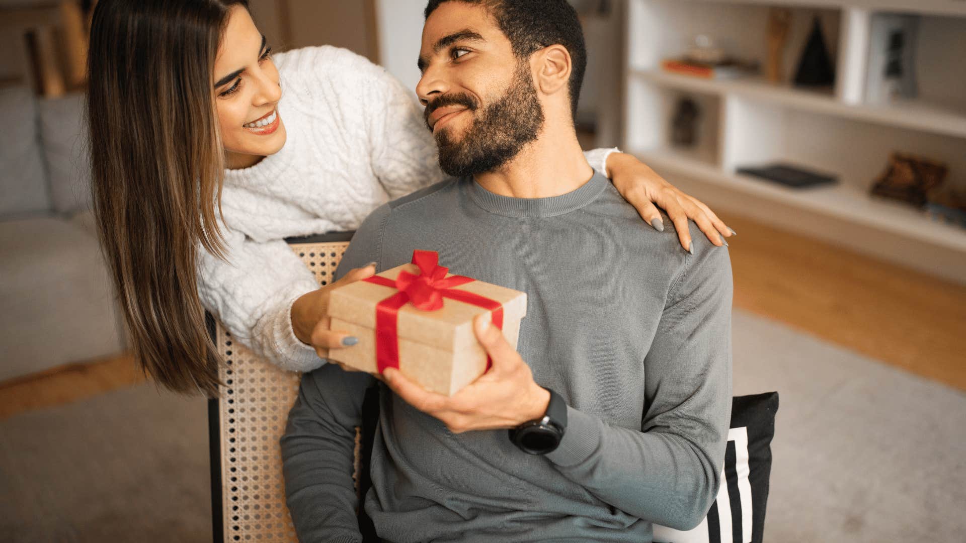 woman giving man a gift