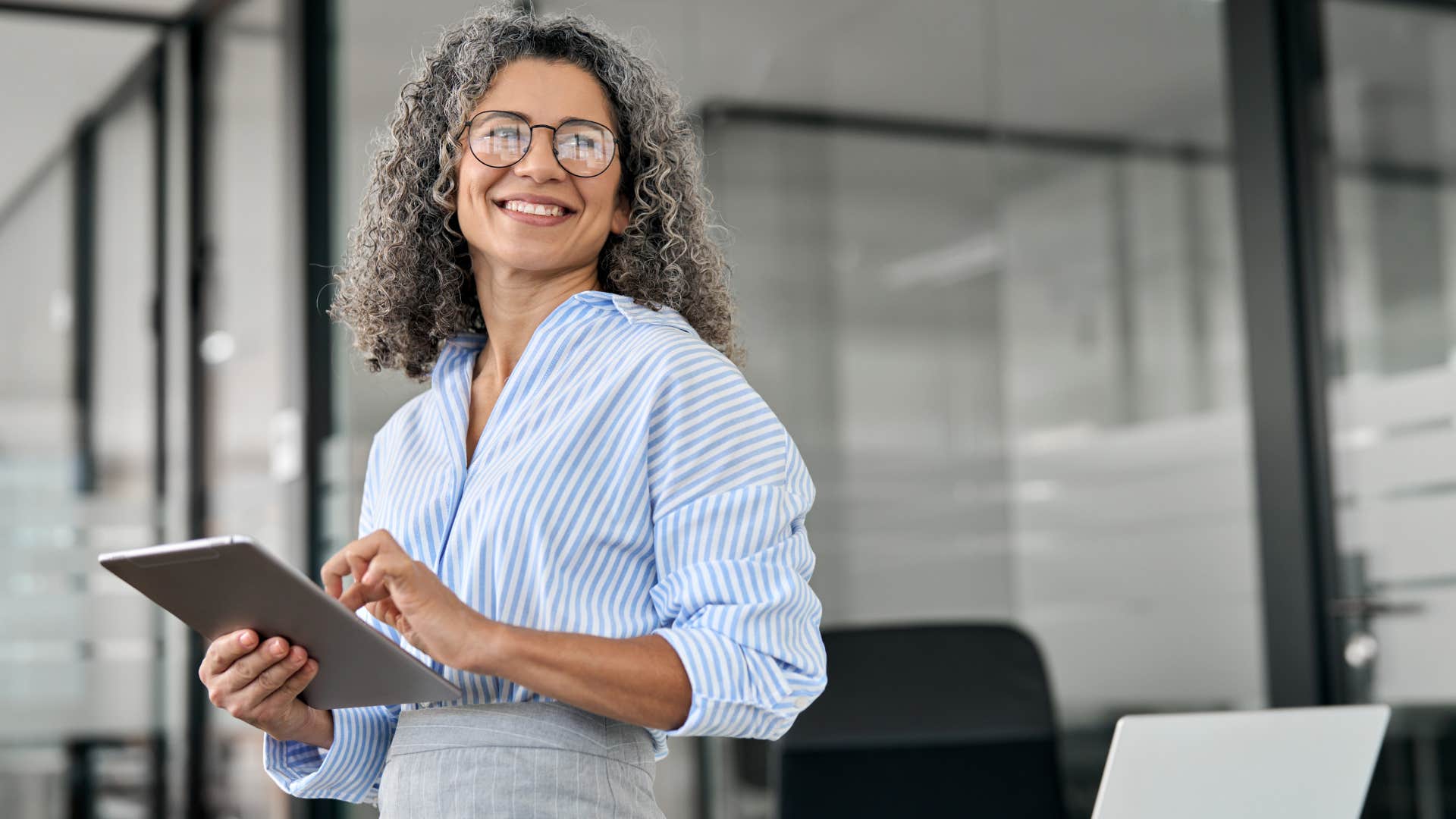 Professional woman smiling in her office.