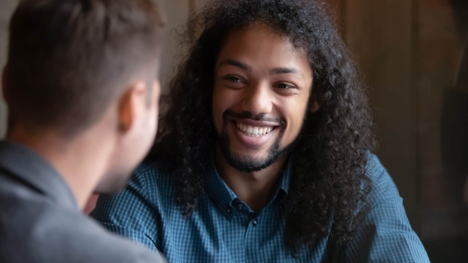 Man smiling at a co-worker.