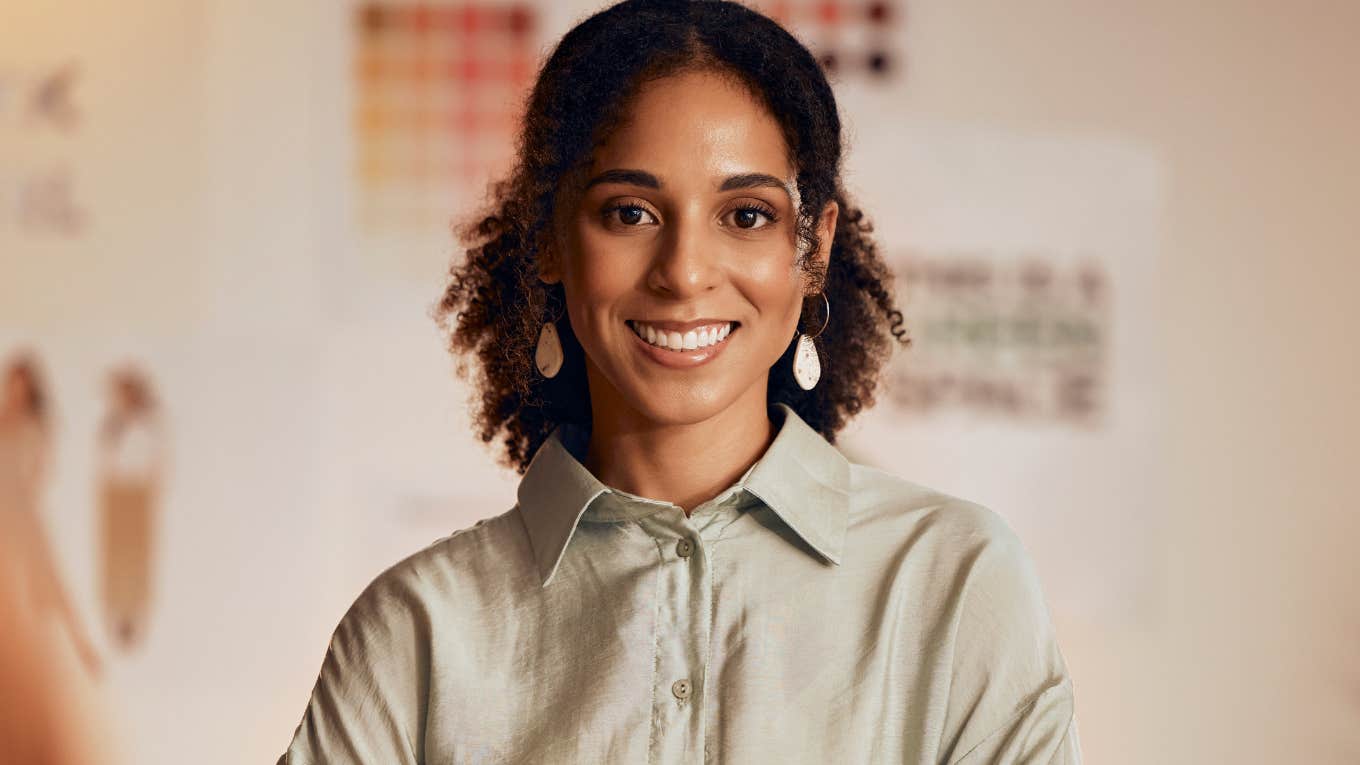 Confident woman smiling in an office.