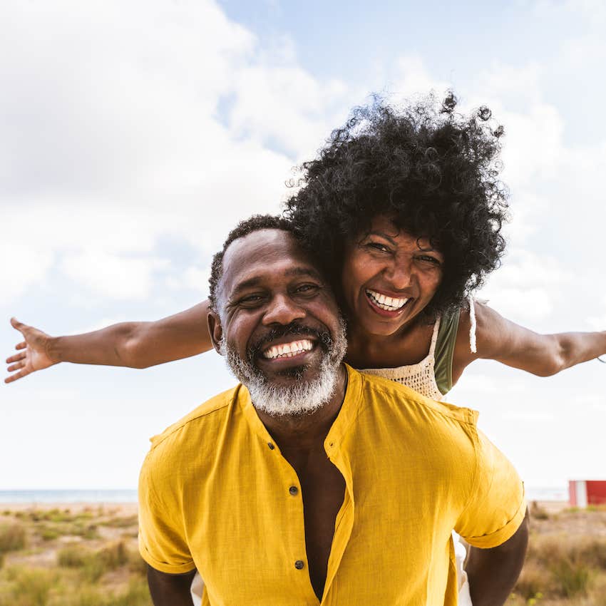 Happy man and woman are playful outside