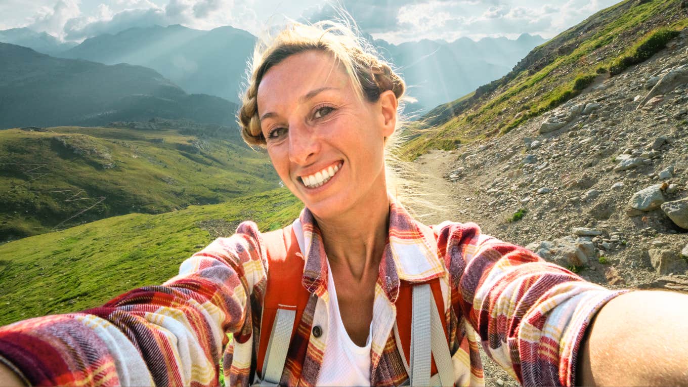 Woman hiking, taking a mental break.