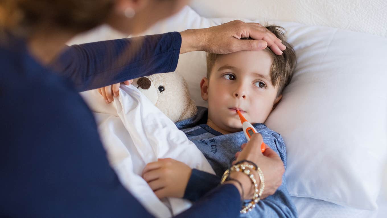 Mom checking the temperature of her sick kid