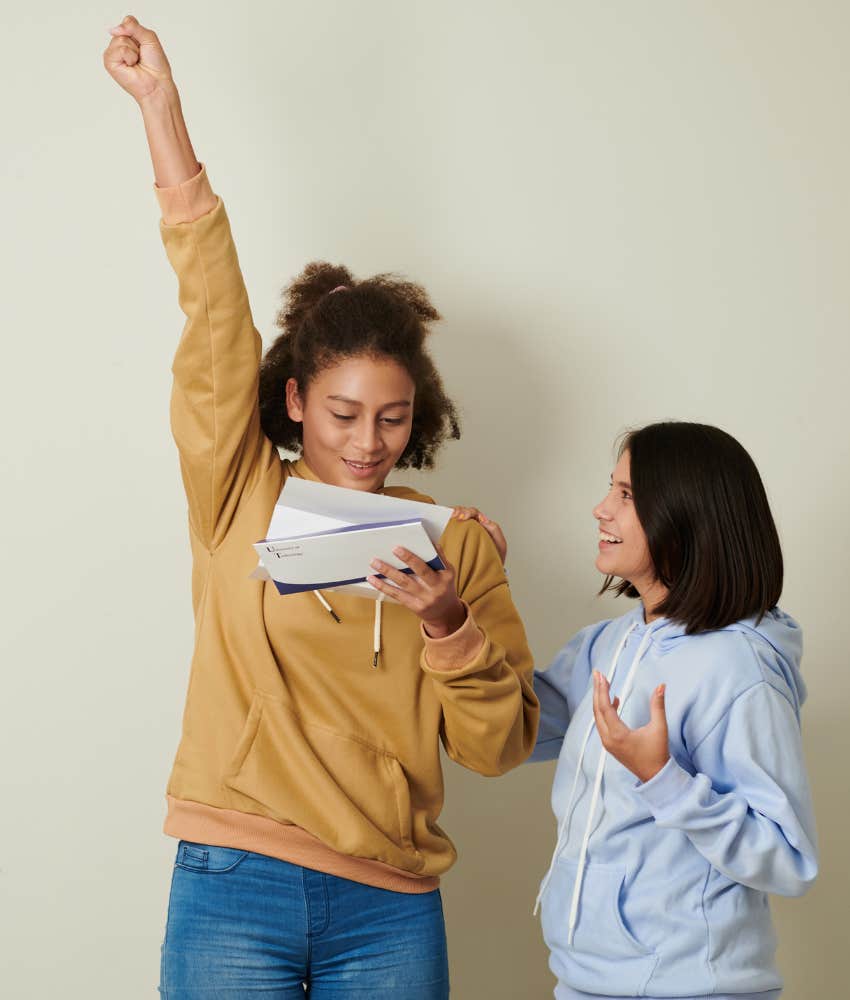 young woman celebrating college acceptance with sister