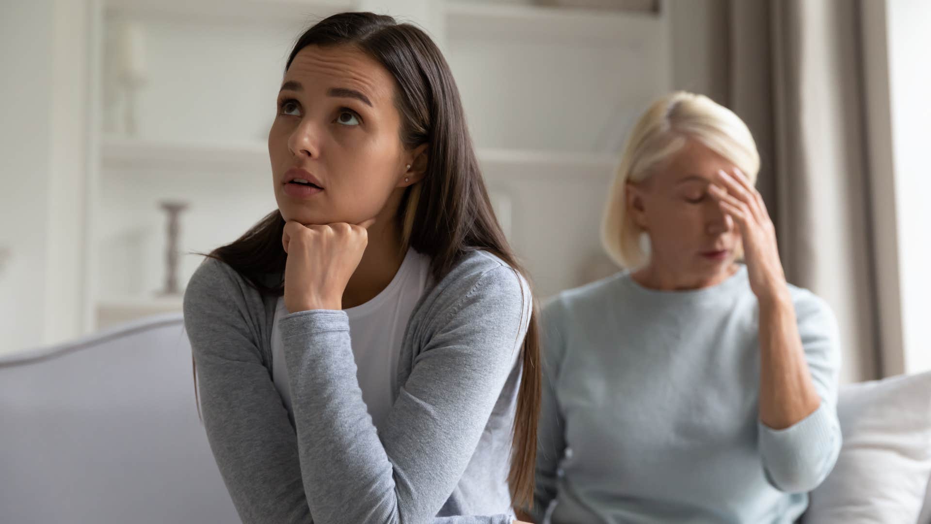 Adult woman turned away from her upset mother.