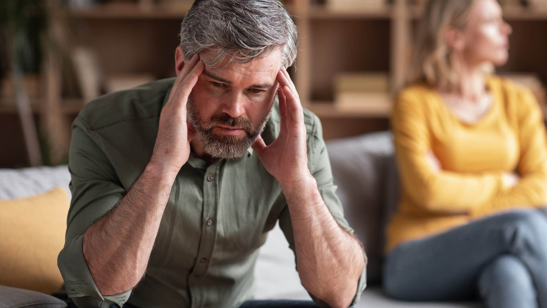 Older man looking upset in front of his daughter.