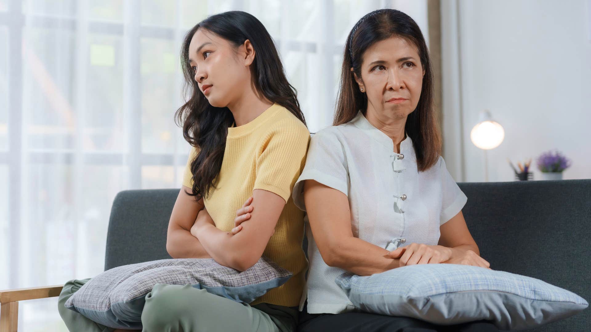 Young woman turned away from her upset mother.