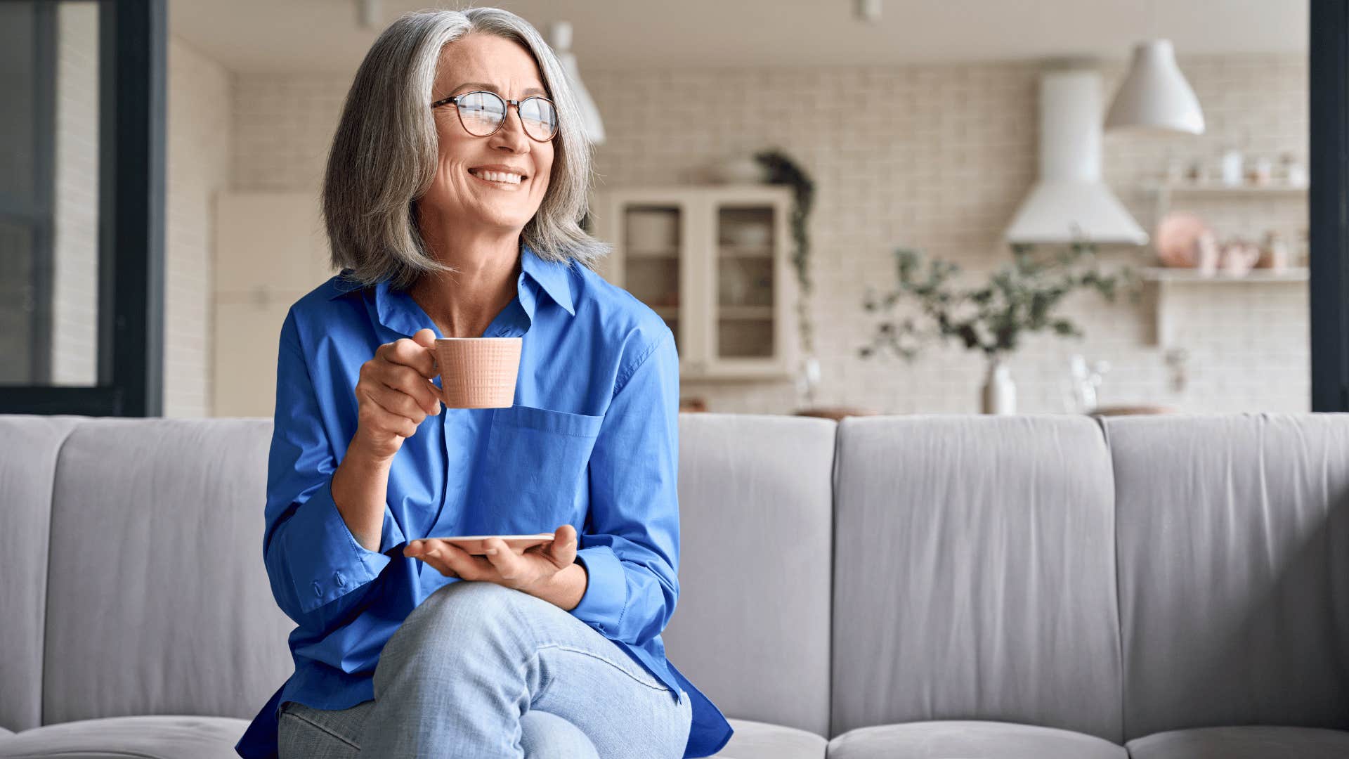 older woman drinking tea while smiling