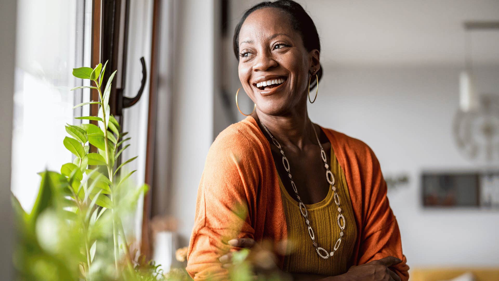 woman smiling while staring out of the window