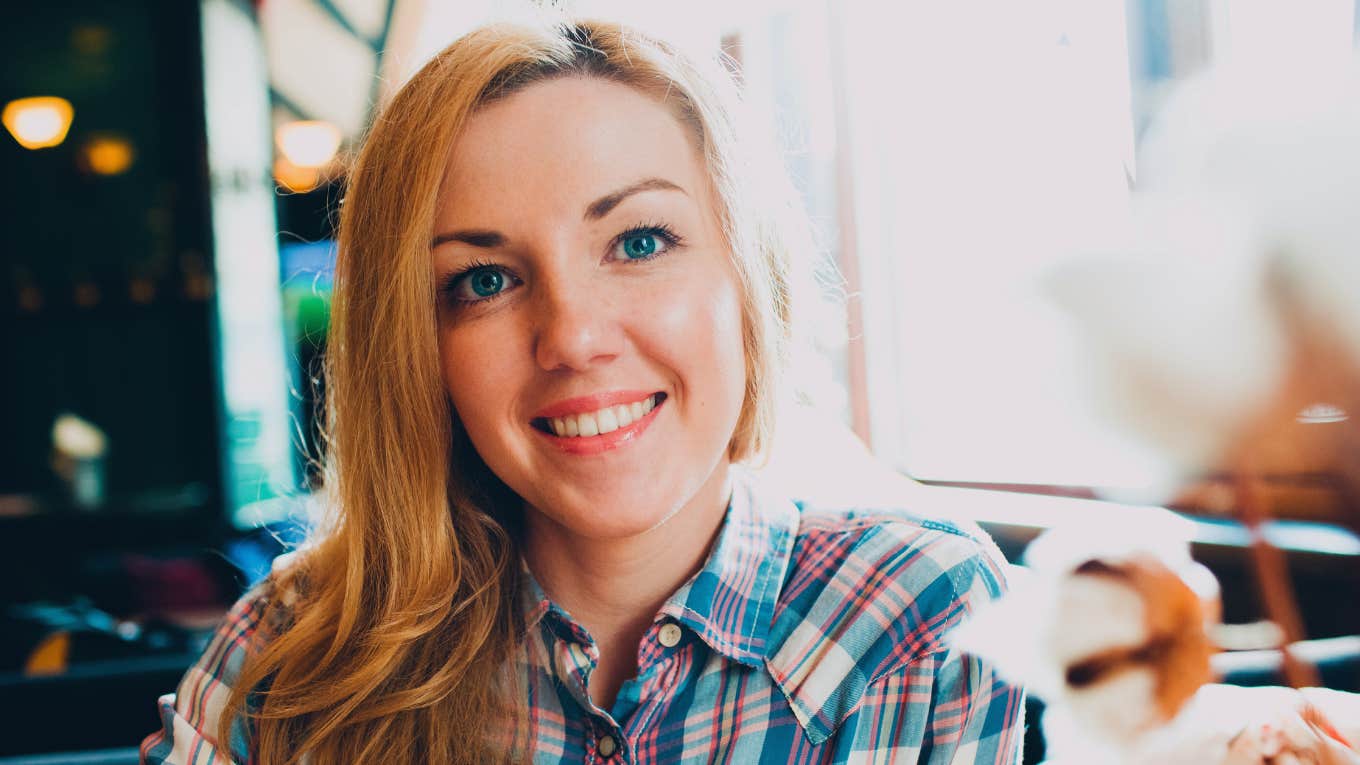 intuitive smiling woman in plaid blue shirt