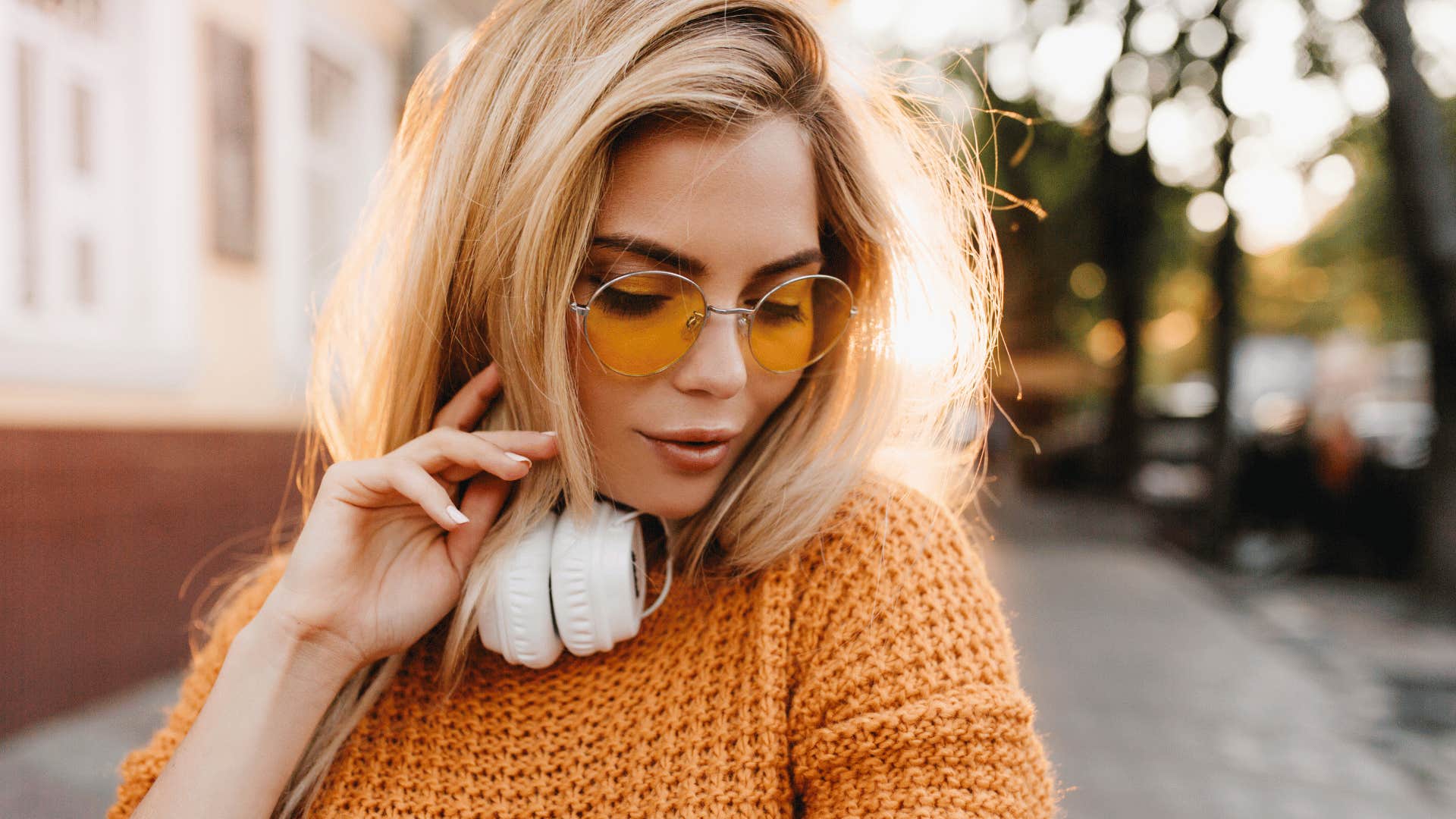 woman wearing sunglasses and headphones