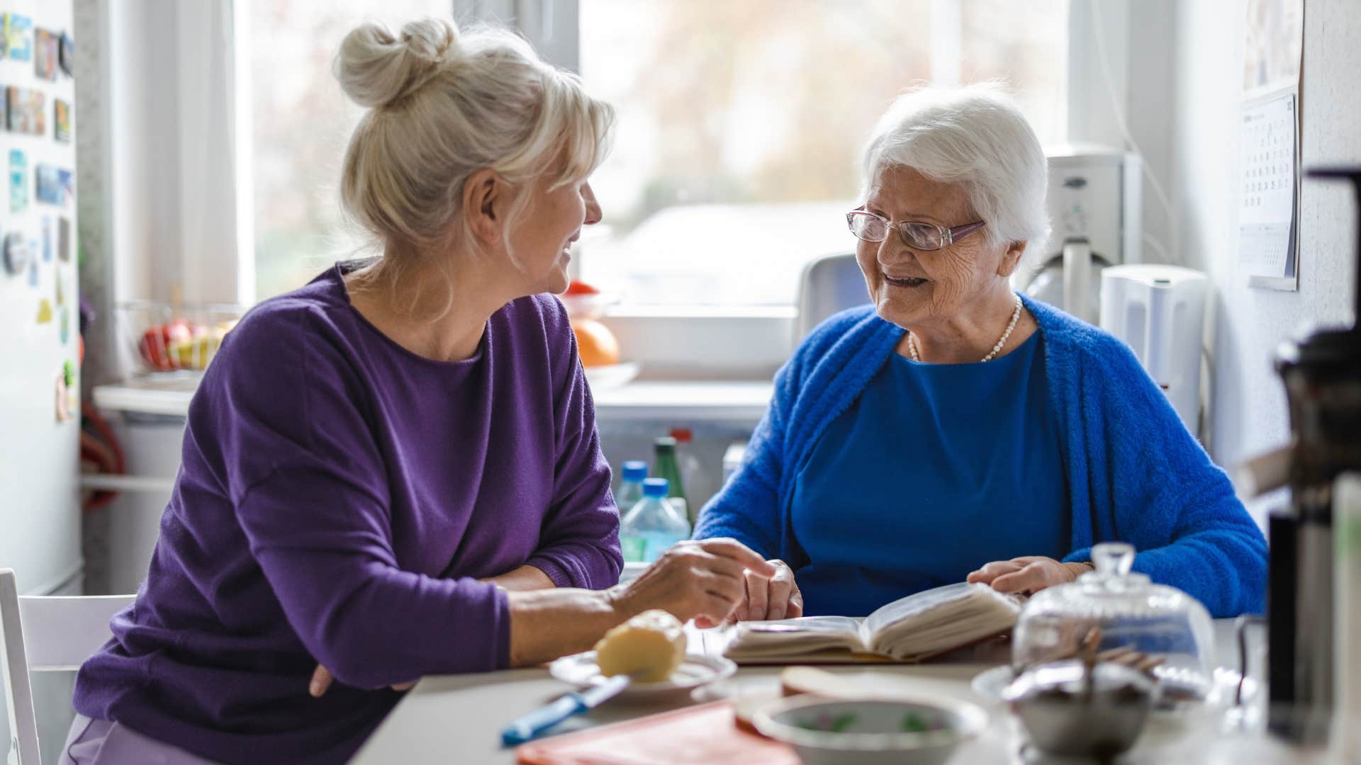 Woman smiling and looking at her older mother