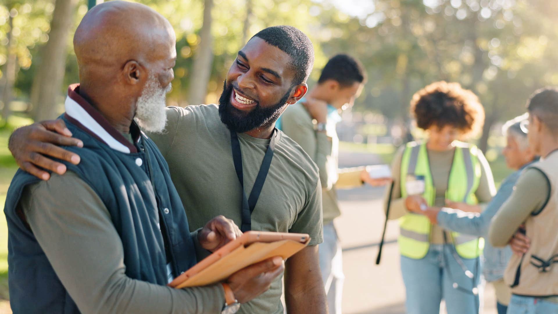 Young man smiling and hugging a Gen X man