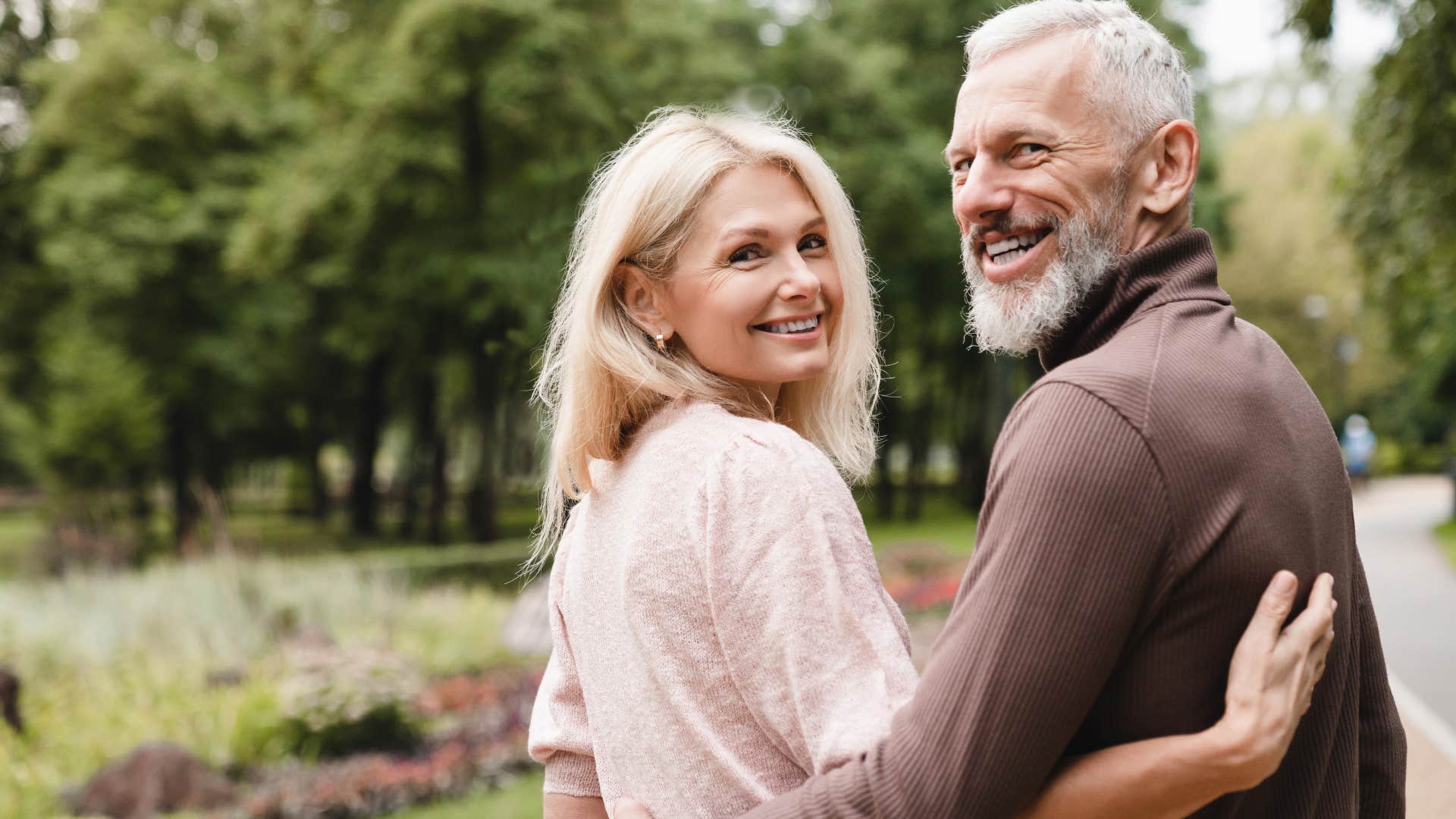 Gen X couple smiling and walking together outside