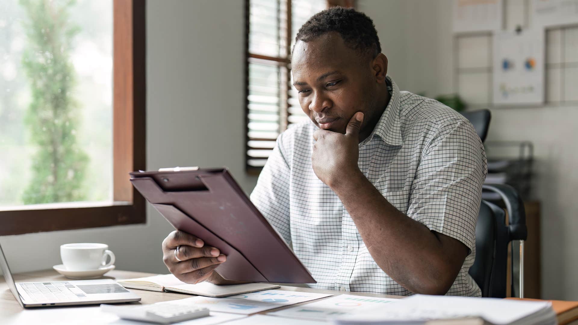 Gen X man looking stressed doing bills