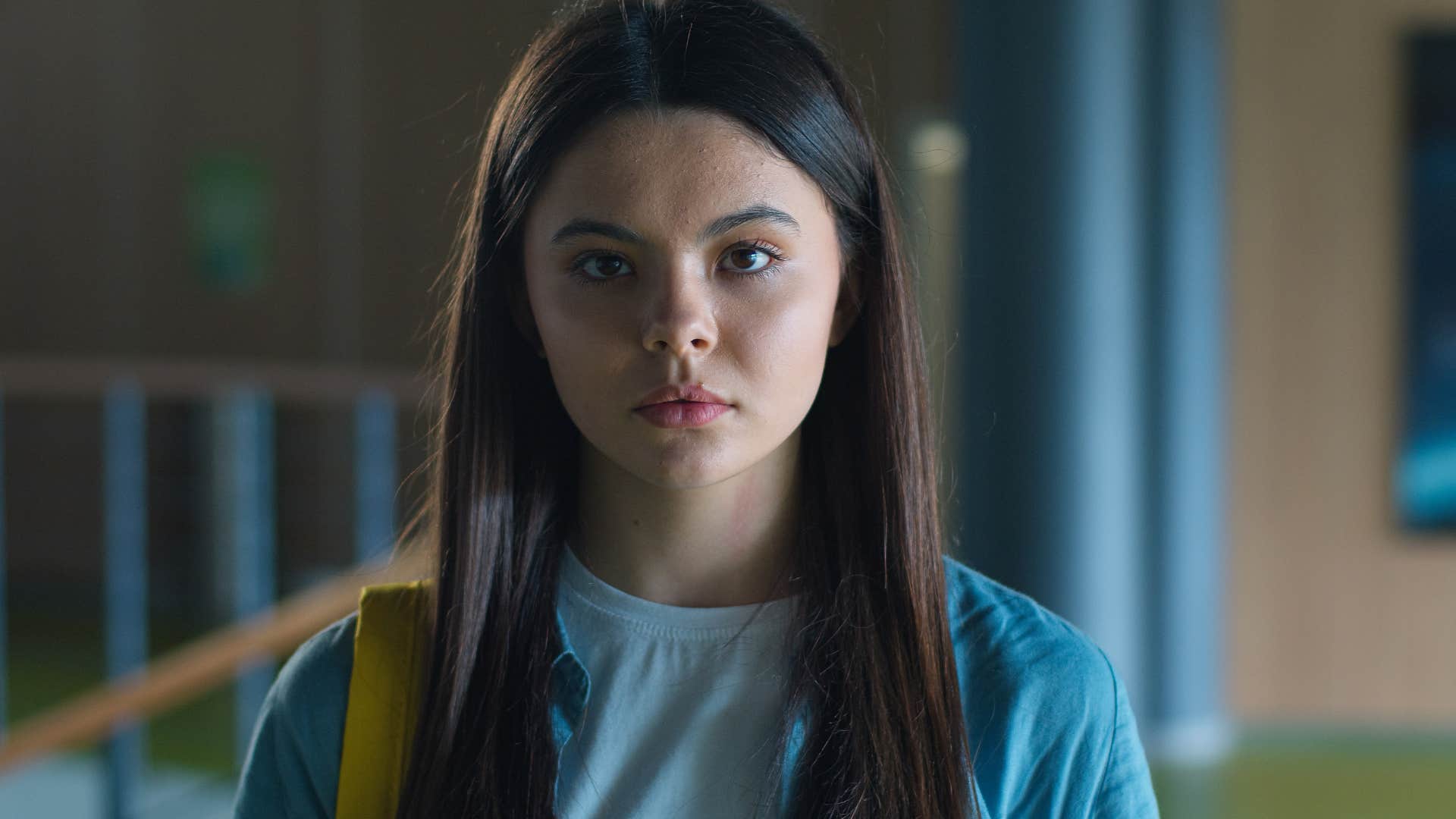 Young woman looking upset in the school hallway