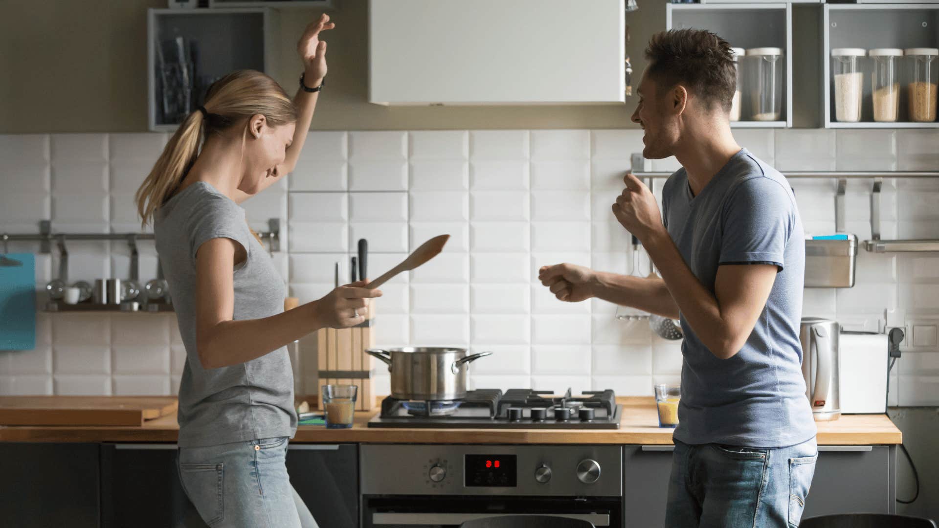 couple singing and dancing in kitchen