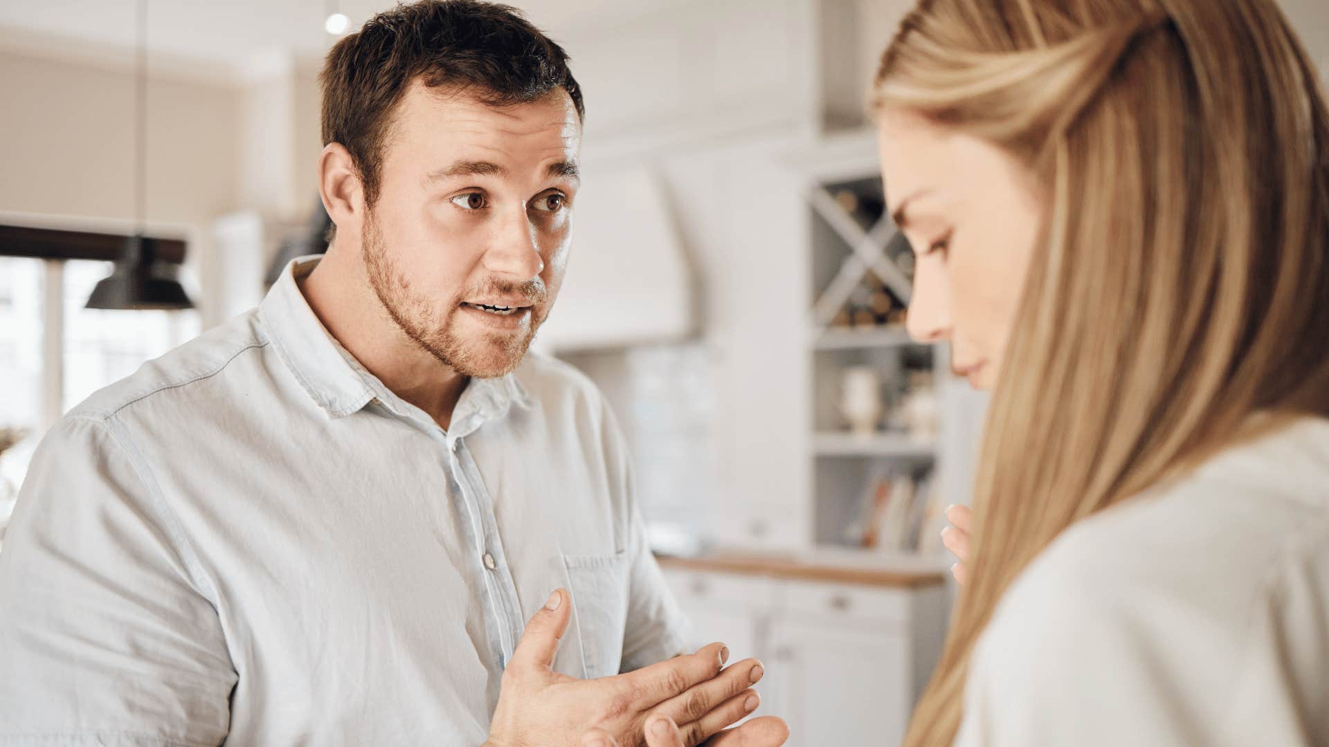 upset man talking to woman